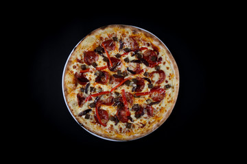 pizza with Pepperoni vegetables isolated on a black background