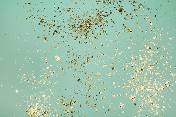 Golden flying sparkles on blue holiday background. Festive backdrop for your projects. - 331558108
