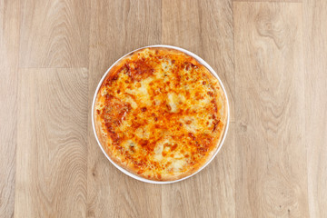 mix cheeses pizza on a wooden background