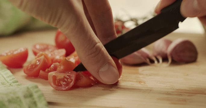 Cutting onion and tomatoes on a chopping board