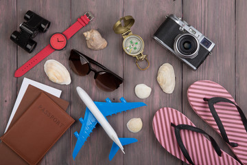 Fototapeta na wymiar Travel concept - Airline tickets, passport, sunglasses and camera on wooden background