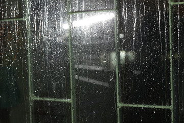 raindrop on glass window with blur background