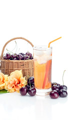 Basket with cherries and juice on a white background close-up