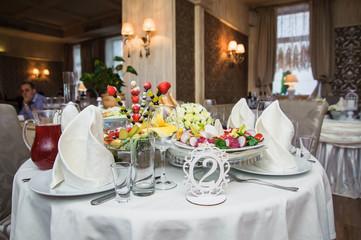 Rich banquet service. Wedding banquet. Catering food, snacks with cheese. Salad with shrimp. Different colorful meals for breakfast or lunch time. Restaurant interior