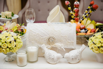 Wedding floral table decoration. Bouquet of flowers. Banquet service. Catering food, snacks with cheese, candles. Different colorful meals for breakfast or lunch time. Restaurant interior