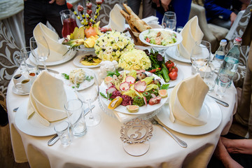 Rich banquet service. Wedding banquet. Catering food, snacks with cheese. Salad with shrimp. Different colorful meals for breakfast or lunch time. Restaurant interior