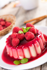 Delicious panna cotta dessert with raspberries sauce