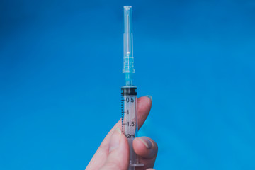 Self-administration of a solution in a transparent ampoule. Against drugs. Treatment for COVID 19 or Wuhan infection virus. Pandemic and vaccination concept, vaccinations for children and adults.