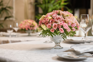 Colorful wedding bouquet on a restaurant served table. Bridal bouquet. Luxury royal restaurant. Valentine's day, birthday, dating or mother's day decoration