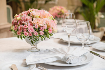 Colorful wedding bouquet on a restaurant served table. Bridal bouquet. Luxury royal restaurant. Valentine's day, birthday, dating or mother's day decoration
