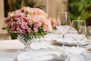 Colorful wedding bouquet on a restaurant served table. Bridal bouquet. Luxury royal restaurant. Valentine's day, birthday, dating or mother's day decoration