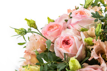 Fresh, lush bouquet of colorful flowers for present isolated on white background. Wedding bouquet of pink roses and freesia flowers
