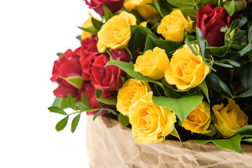 Fresh, lush bouquet of colorful flowers for present . Wedding bouquet of red and yellow roses and freesia flowers. Macro, close-up