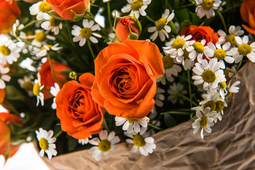 Fresh, lush bouquet of colorful flowers for present.  Wedding bouquet of red roses and freesia flowers. Close-up, macro