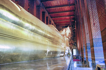 Reclining Buddha at Wat Pho Buddhist temple complex in the Phra Nakhon District, Bangkok, Thailand. Religious monument, tourist attraction
