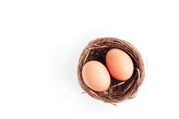 Two eggs in a nest on a white background, isolated