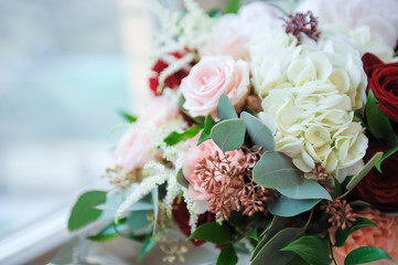 Colorful wedding bouquet on a bed. Bridal bouquet, white bedding. Luxury hotel room. Valentine's day or mother's day present