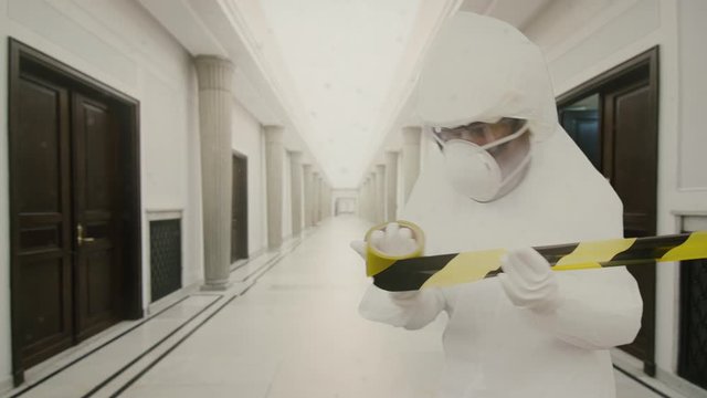 An Empty Corridor In A Public Administration Building During A Global Pandemic.
Striped Protective Tape In Slow Motion. Copy Space For Text Or Other Content