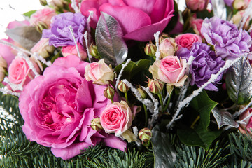 Fresh, lush bouquet of colorful flowers for present isolated on white background. Wedding winter bouquet of purple and white roses and freesia flowers. Christmas bouquet