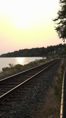 Fototapeta premium Horizon view of the ocean near a train-track in White Rock British Columbia
