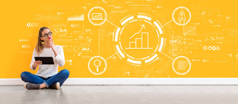 Business growth analysis with young woman holding a tablet computer