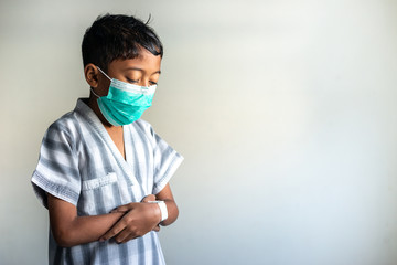 Young Muslim Boy wearing a mask praying. Covid-19 coronavirus concept. Shallow depth of field.