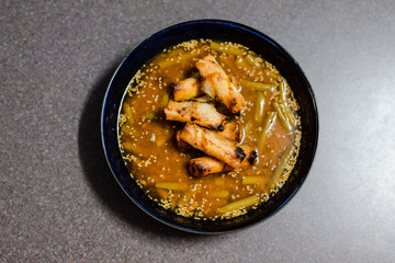 spicy asian soup with vegan broth and vegetable spring rolls
