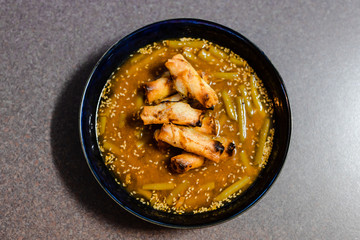 spicy asian soup with vegan broth and vegetable spring rolls