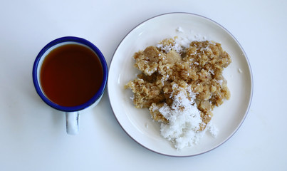 Tiwul and a cup of tea on white background. Tiwul is Indonesian traditional food. Made ​​from dried cassava (tapioca).               