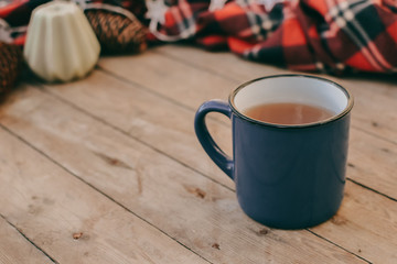 Flat lay winter and autumn cozy vintage background with copy space. The cup of tea or coffee on wooden table. Christmas atmosphere.