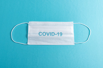 Surgical mask over minimalist blue background