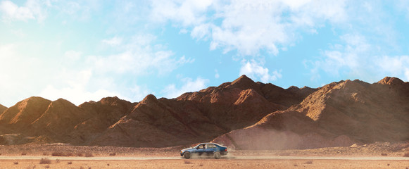 a scenery of a car riding in the center of a sandy road among the mountains with cloudy sky