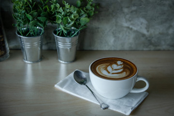 Digital tablet and cup of coffee on old wooden desk. / selective focus