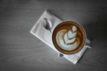 Hot coffee cup on a wooden table.