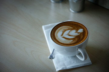 Hot coffee cup on a wooden table.