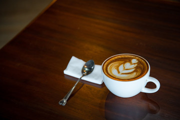 Hot coffee cup on a wooden table.