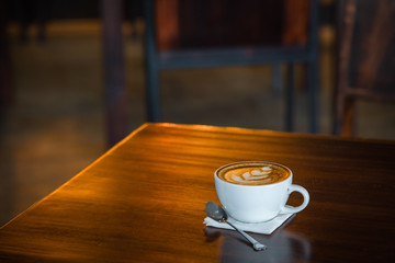 Hot coffee cup on a wooden table.