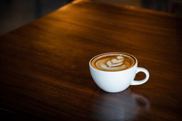 Hot coffee cup on a wooden table.