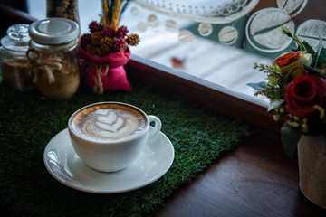 Digital tablet and cup of coffee on old wooden desk. / selective focus