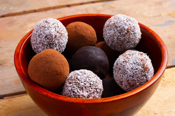 Homemade truffles with hazelnut on dark wooden background