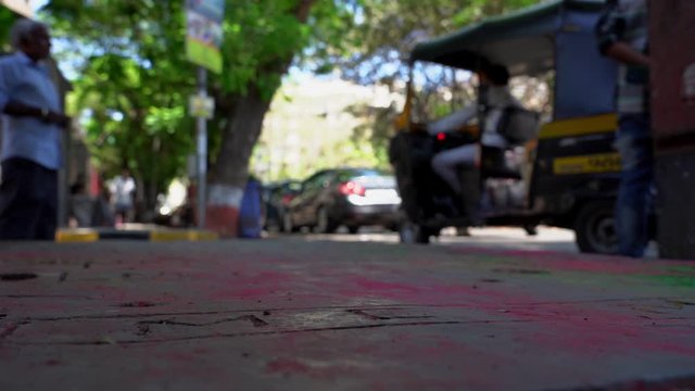 Pavement footpath in Mumbai India covered with colors after the festival of Holi