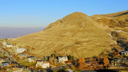 Early morning aerial approach towards Ensign Peak in Salt Lake City Utah