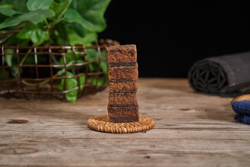 Brown sugar is placed in a wooden plate against the backdrop of a vintage old wooden board. Red ginger sugar blood food