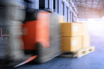 Speed motion blur of forklift driver loading pallet shipment goods, warehouse industry delivery...