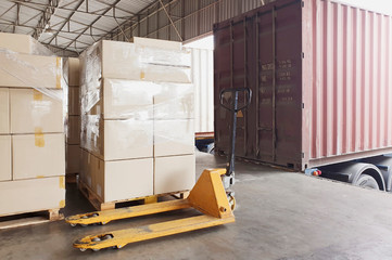 Packaging Boxes on Pallets Loading into Cargo Container. Loading Dock Shipping Trucks. Supply...