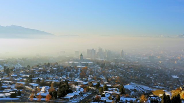 Flying toward Salt Lake City Capitol and Downtown on smoggy winter morning