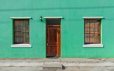 Fototapeta na wymiar Vintage green turquoise facade in the Malay district of Bo Kaap in Cape Town, South Africa.