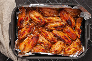 Grilled chicken wings on foil food. Top view. Foil pack dinners.