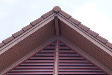 Gable roof of wooden red house.