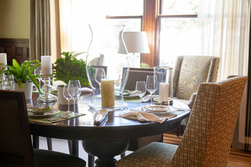 Modern dining room set up for a fun celebration with candlesticks, wine glasses, cloth napkins